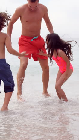 Father-and-children-jumping-in-the-sea