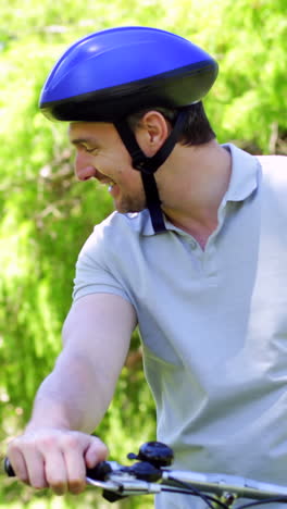 Father-and-young-son-on-a-bike-ride-in-the-park-together