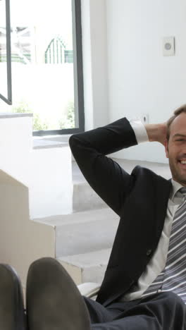 Businessman-smiling-and-relaxing-on-a-chair