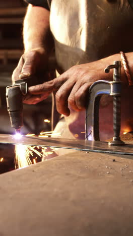 Mid-section-of-welder-using-welding-torch