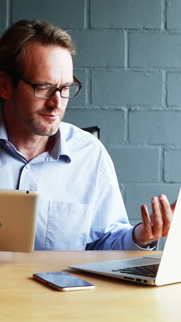 Businessman-interacting-with-client-over-video-calling-on-laptop