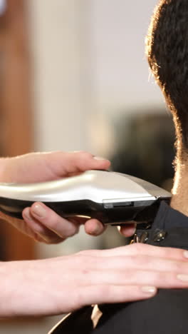 Man-getting-his-hair-trimmed-with-trimmer