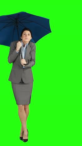 Businesswoman-standing-under-umbrella