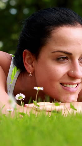 Pretty-brunette-lying-down-on-the-grass