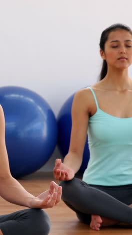 Fit-women-doing-yoga-together-in-studio