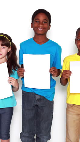 Cute-little-children-covering-face-with-white-paper