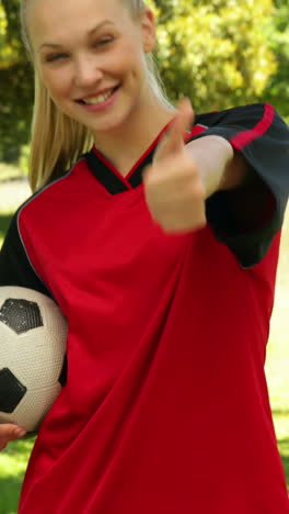 Blonde-football-player-smiling-and-giving-thumbs-up-to-camera