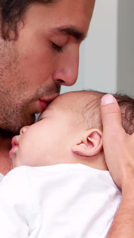 Handsome-father-holding-his-baby