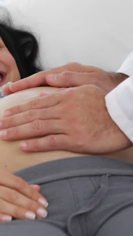 Brunette-pregnant-woman-being-checked-by-doctor