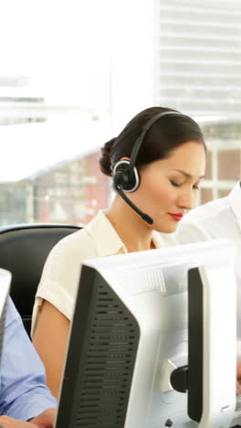 Manager-checking-on-call-centre-employees