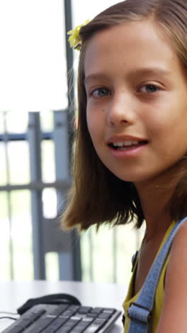 Schoolgirl-using-computer-in-classroom