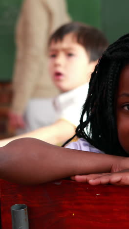 Little-girl-smiling-at-the-camera-during-class