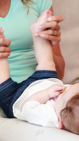 Mother-playing-with-her-baby-son-on-the-couch