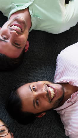 Portrait-of-businesspeople-lying-on-the-floor