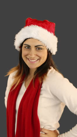 Woman-in-santa-hat-and-warm-clothing-blowing-over-hands-