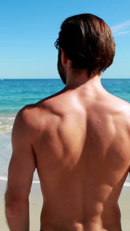 Man-standing-on-beach