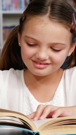 Schoolgirl-reading-book-in-library