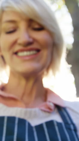 Mature-woman-holding-young-plant