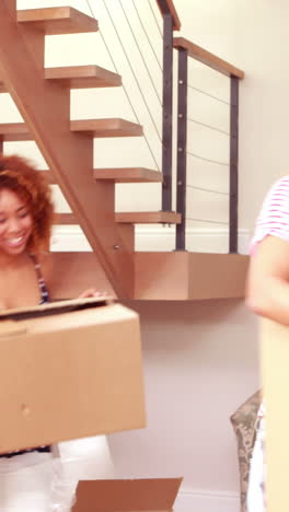 Smiling-friends-moving-boxes-together