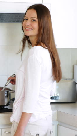 Pretty-woman-preparing-dinner-at-the-stove