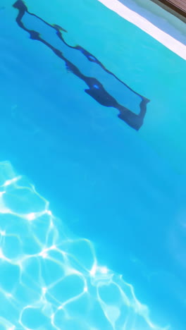 Brunette-diving-into-clear-blue-pool