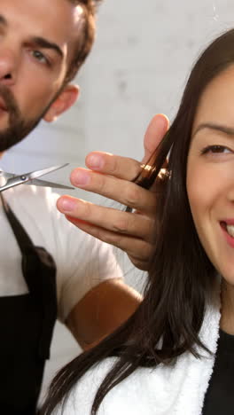 Woman-getting-his-hair-trimmed-with-scissor