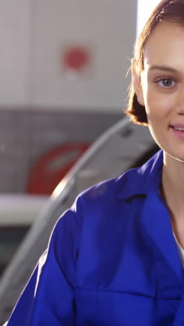 Female-mechanic-holding-lug-wrench-and-showing-thumbs-up