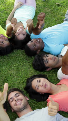 Group-of-casual-young-friends-lying-in-a-circle