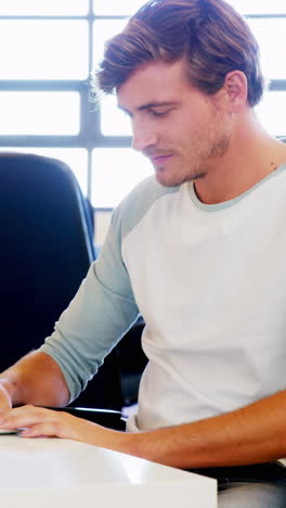 Smiling-man-working-on-laptop