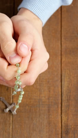 Praying-hands-holding-rosary