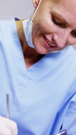 Dentist-examining-a-male-patient-with-dental-tools