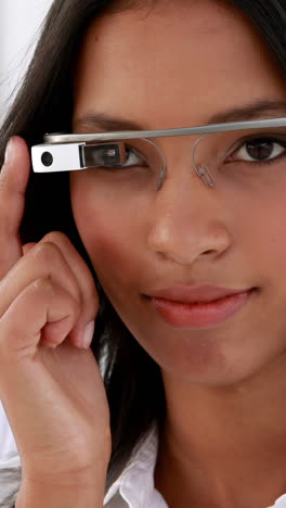 Businesswoman-smiling-at-camera-using-smart-glasses