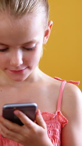 Schoolgirl-using-mobile-phone-in-classroom