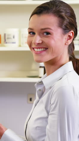 Pharmacist-checking-a-bottle-of-drug-in-pharmacy