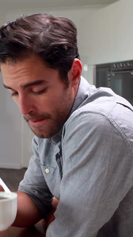 Handsome-man-drinking-coffee-and-using-laptop