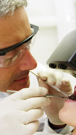 Female-patient-using-virtual-reality-headset-during-a-dental-visit