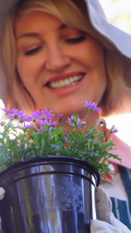 Mature-woman-checking-plant