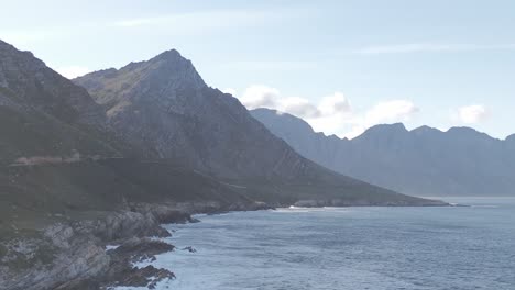 Drone-shot-of-a-sea-in-Cape-Town-surrounded-by-mountains