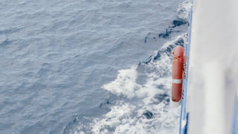 Serene-sea-voyage,-lifebuoy-on-boat,-sunny-Mediterranean-day