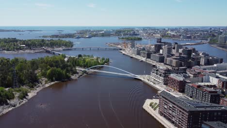 Helsinki-aerial-pulls-back-at-pedestrian,-cycling-Isoisansilta-Bridge