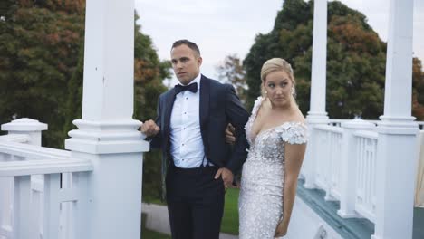 Bride-and-groom-stand-at-luxury-hotel