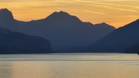 A-beautiful-sunset-in-the-region-of-Walensee,-Wessen,-Amden,-Quinten,-Mols,-and-Walenstadt,-with-the-stunning-silhouettes-of-the-Swiss-Alps-in-the-background