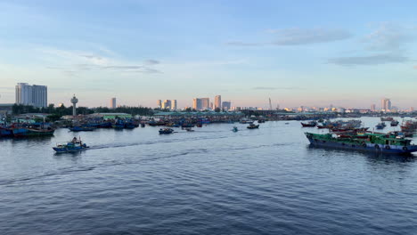 established-of-da-nang-Vietnam-famous-tourist-fisherman-colonial-town-at-sunset,-view-from-port-with-skyline-cityscape-at-distance