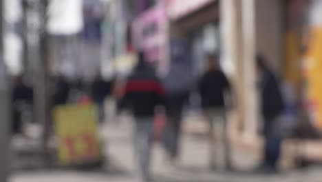 busy-sidewalk-ppl-walking-in-front-of-local-business