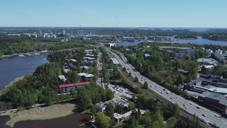 Baltic-aerial:-Freeway-traffic-into-Helsinki-crossing-Kulosaari-Island