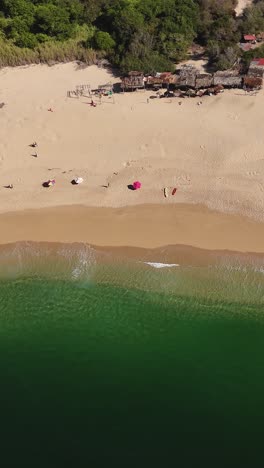 Aerial-view-of-Cacaluta-Beach-in-Huatulco,-Oaxaca,-vertical-mode