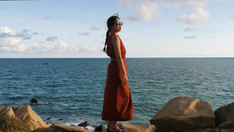 Beautiful-model-posing,-hidden-beach-retreat,-ocean-water,-slow-motion