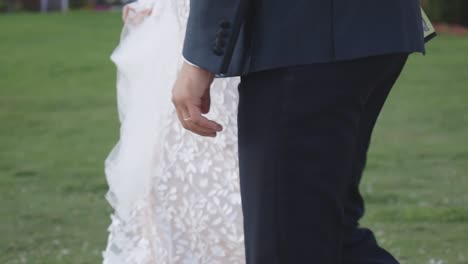 Bride-and-groom-hold-hands-walking