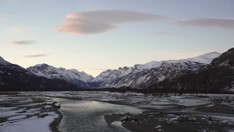 Wide-shot-of-river-and-snowy-mountains-in-Patagonia-at-sunrise