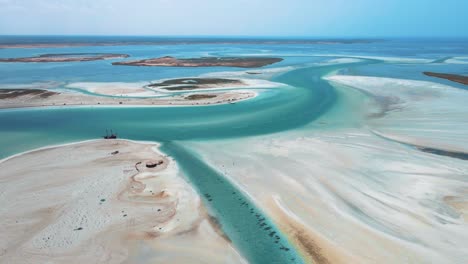 Eine-Luftaufnahme-Der-Aquatischen-Strandszene-Von-Hassi-El-Jerbi-Mit-Menschen-Und-Booten-Im-Wasser-Bei-Zarzis,-Tunesien